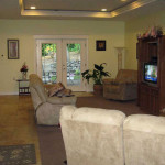 Living room at West Linn Care Home with lots of couches and a glass door that leads out to the patio