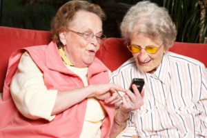 Elderly women looking at cell phone